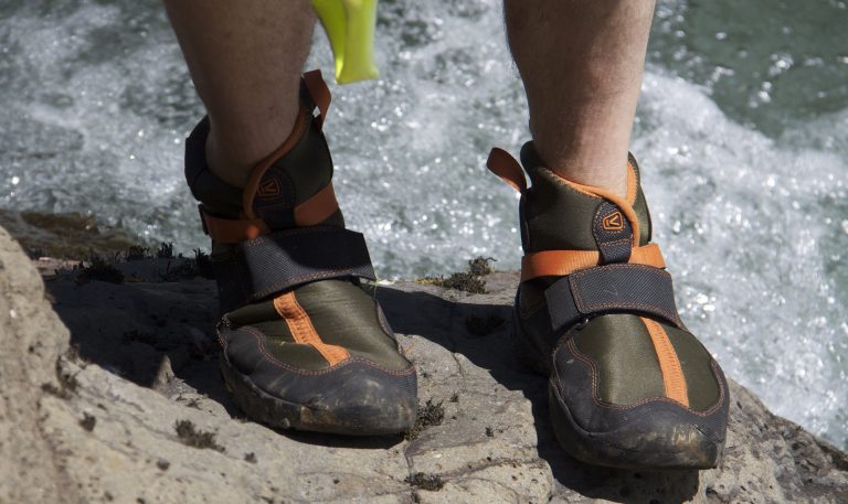 Best-Water-Shoes-stepping-on-rock-coming-out-of-river-768x457.jpg